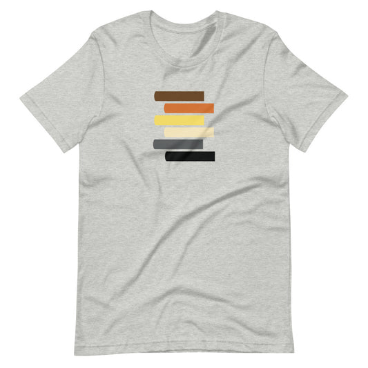 A gray t-shirt with a graphic design featuring horizontal lines in various shades of brown, black, white, and yellow on the front.