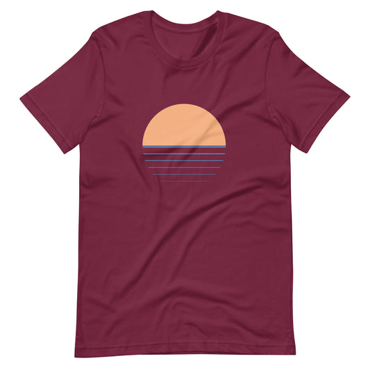 A red t-shirt with a graphic of a sunset and a wave pattern across the front.