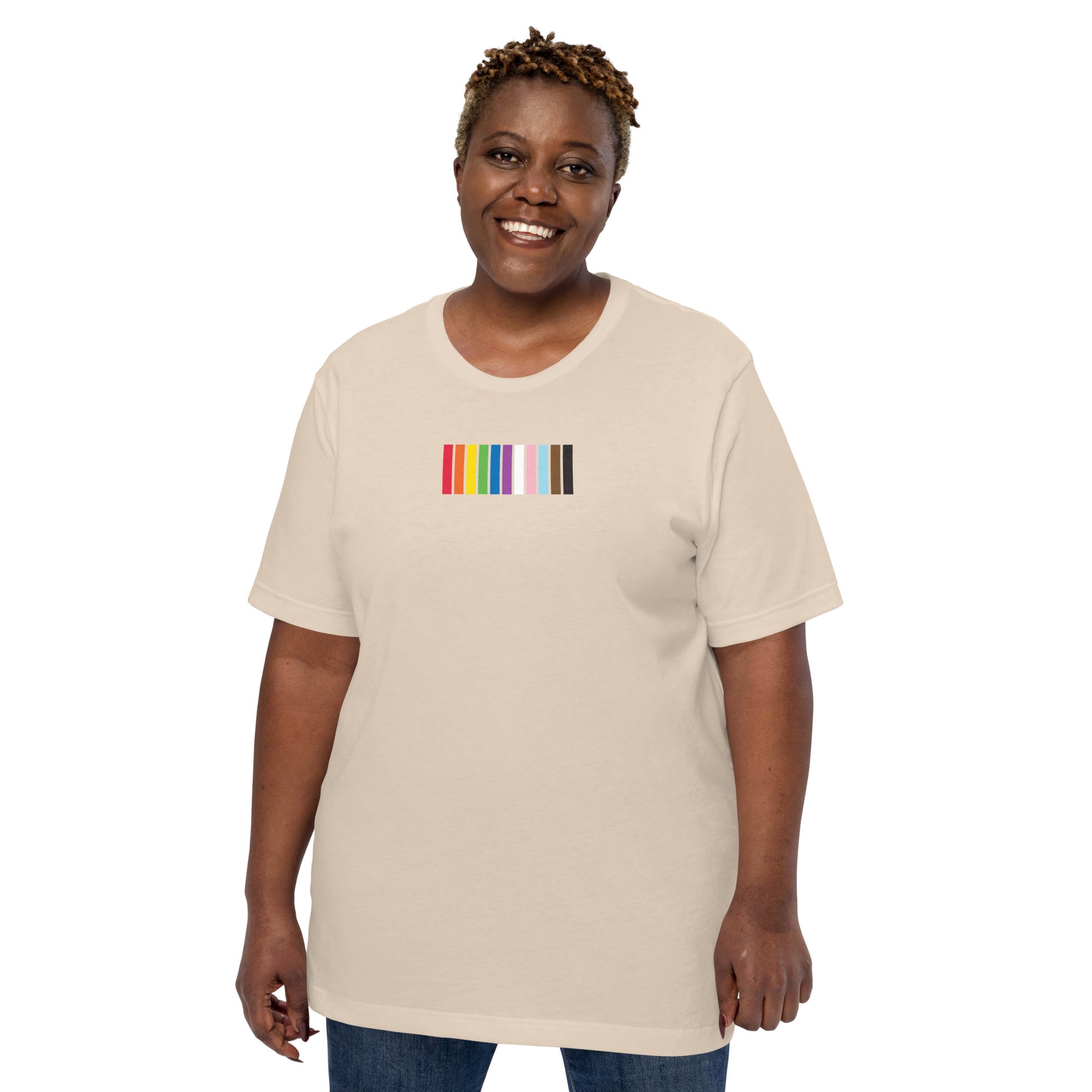 A woman wearing a beige t-shirt with a colorful striped design on the front representing the LGBTQ+ community.