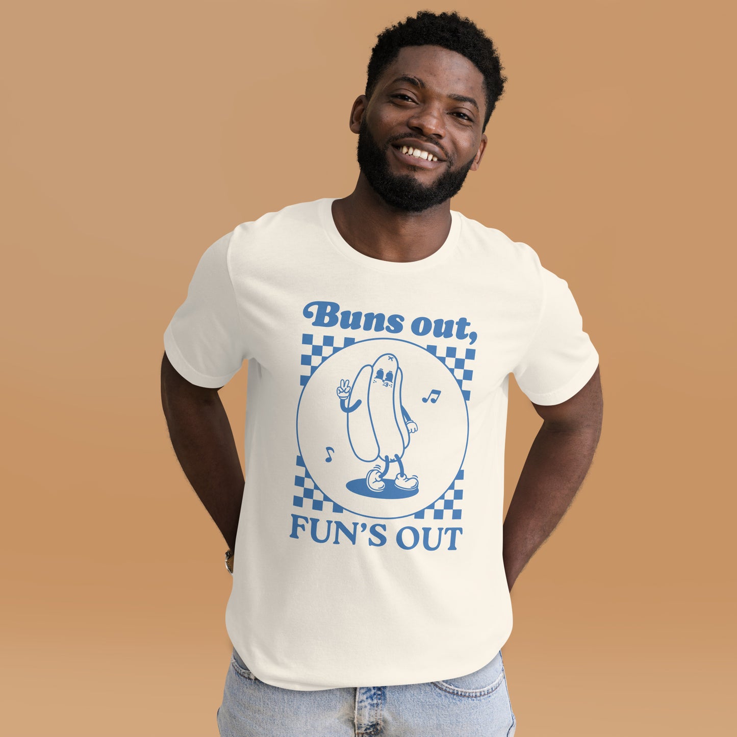Man wearing a white t-shirt with a blue graphic of a cartoon hot dog and text that says “Buns out, FUN’S OUT.”