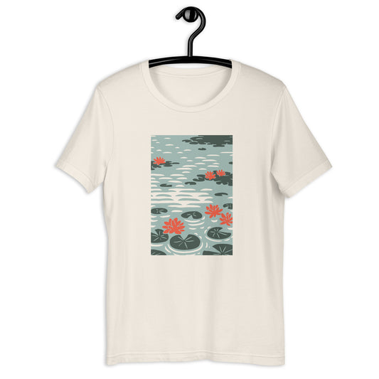 A white t-shirt with a graphic print of water lilies inspired by Claude Monet's artwork.